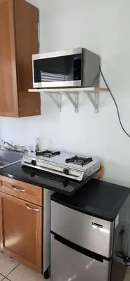 a kitchen with a stove and a microwave at 13101 Main Apartment Miami in Miami
