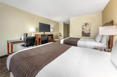 a hotel room with two beds and a desk at Best Western Plus North Miami-Bal Harbour in North Miami