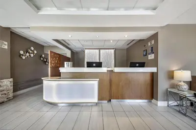 an office lobby with a reception counter and a desk at Best Western Plus North Miami-Bal Harbour in North Miami
