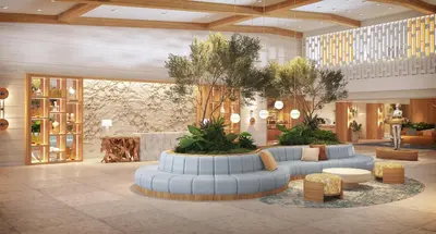 a lobby with couches and tables in a building at The Sunny in Sunny Isles Beach