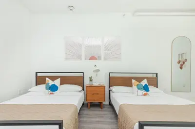 a bedroom with two beds and a nightstand between them at West Deco in Miami Beach