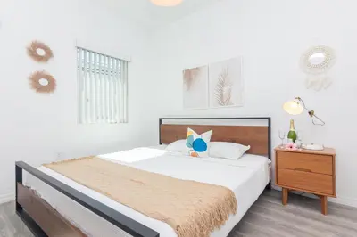 a bedroom with a large bed and a night stand at West Deco in Miami Beach