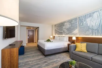 a hotel room with a bed and a couch at B Ocean Resort Fort Lauderdale Beach in Fort Lauderdale