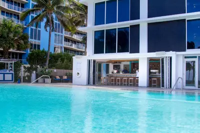 a swimming pool in front of a building at B Ocean Resort Fort Lauderdale Beach in Fort Lauderdale