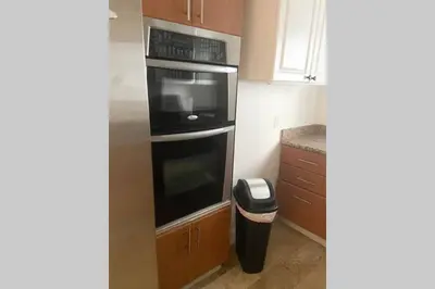 a kitchen with a black oven and a trash can at Comfortable 2 BR at Brickell , Free Parking in Miami