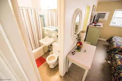 a bathroom with a sink and a toilet and a mirror at Ocean Inn in Hollywood