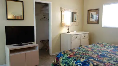 a bedroom with a bed and a flat screen tv at Ocean Inn in Hollywood