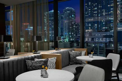 a restaurant with couches and tables and a city skyline at Element Miami Brickell in Miami