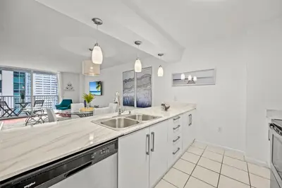 a kitchen with a sink and a living room at Amazing Condo with FREE PARKING in Brickell Miami in Miami