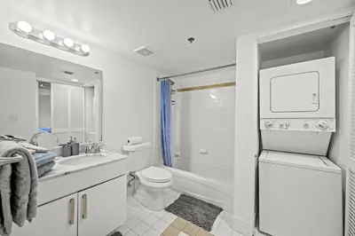 a white bathroom with a toilet and a sink at Amazing Condo with FREE PARKING in Brickell Miami in Miami