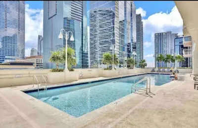 a large swimming pool in a city with tall buildings at Amazing Condo with FREE PARKING in Brickell Miami in Miami