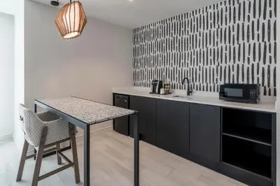 a kitchen with a sink and a table with a microwave at Atwell Suites Miami Brickell by IHG in Miami