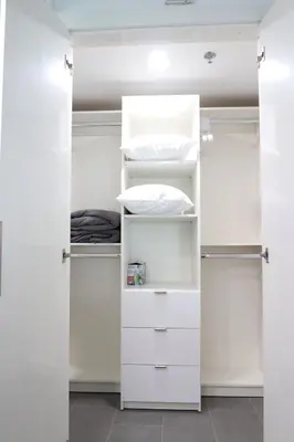 a white closet with white cabinets and shelves at Luxury Accommodations Brickell in Miami
