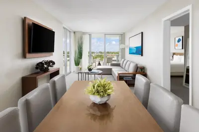 a living room with a table and a couch at The Altair Bay Harbor Hotel in Miami Beach