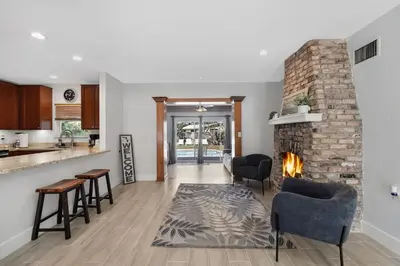 a kitchen and a living room with a fireplace at Home wpool by PMI unit 401 in Fort Lauderdale