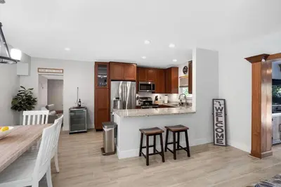 a kitchen and living room with a table and chairs at Home wpool by PMI unit 401 in Fort Lauderdale