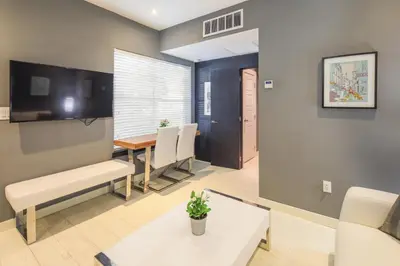 a living room with a dining room table and chairs at Sunny Days Apartments in Miami Beach