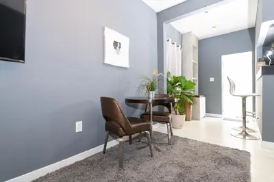a dining room with blue walls and a table and chairs at Sunny Days Apartments in Miami Beach