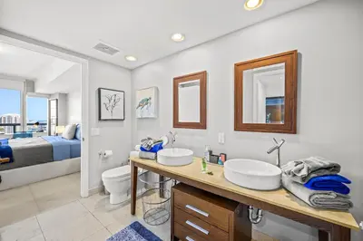 a bathroom with two sinks and a toilet at *ICONIC W ICON CONDO/ POOL&WATERVIEWS*FREESPA* in Miami
