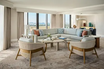 a living room with a couch and tables and chairs at Fort Lauderdale Marriott Harbor Beach Resort & Spa in Fort Lauderdale
