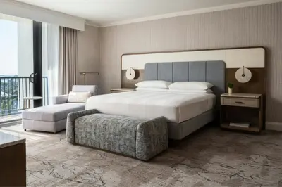 a bedroom with a large bed and a chair at Fort Lauderdale Marriott Harbor Beach Resort & Spa in Fort Lauderdale