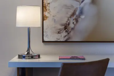 a lamp sitting on a desk with a picture on the wall at Fort Lauderdale Marriott Harbor Beach Resort & Spa in Fort Lauderdale