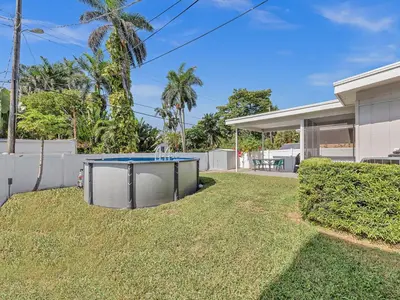 a ping pong table in the yard of a house at SuperVilla - 3BR/2BA - Pool - Walk to beach in Hollywood