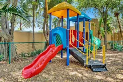 a playground with a slide in a park at Yacht Club Newly renovated parking included in Aventura