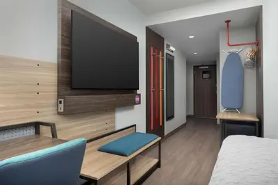 a room with a bed and a flat screen tv at Home2 Suites By Hilton Miami Airport South Blue Lagoon in Miami