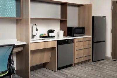 a kitchen with a refrigerator and a microwave at Home2 Suites By Hilton Miami Airport South Blue Lagoon in Miami