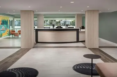 a lobby with a reception desk and two stools at Home2 Suites By Hilton Miami Airport South Blue Lagoon in Miami