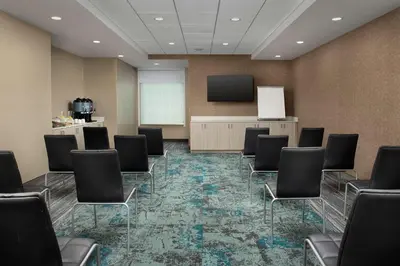 a conference room with chairs and a screen at Tru By Hilton Miami Airport South Blue Lagoon, Fl in Miami