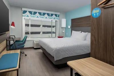 a hotel room with a bed and a desk and a window at Tru By Hilton Miami Airport South Blue Lagoon, Fl in Miami