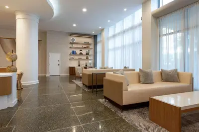 a lobby with couches and tables in a building at Hilton Cabana Miami Beach Resort in Miami Beach
