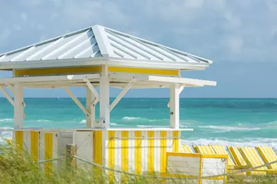 a lifeguard station at the beach with chairs at Hilton Cabana Miami Beach Resort in Miami Beach