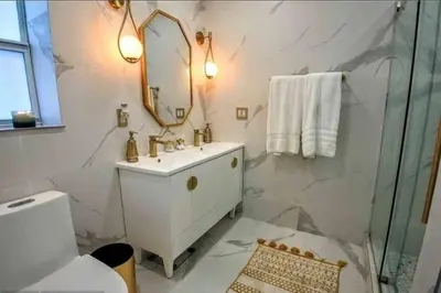 a white bathroom with a sink and a mirror at SWAYING PALM BEACH HOUSE Walk to Beach , Marina, Port, las Olas in Fort Lauderdale
