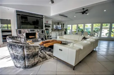 a living room with a couch and a fireplace at SWAYING PALM BEACH HOUSE Walk to Beach , Marina, Port, las Olas in Fort Lauderdale