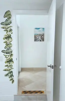 a hallway with a plant on the wall at Pool Villa in Miami