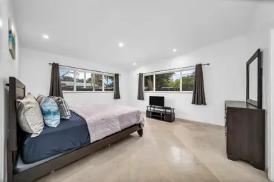 a bedroom with a bed and a flat screen tv at Pool Villa in Miami