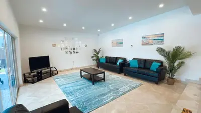 a living room with a couch and a tv at Pool Villa in Miami