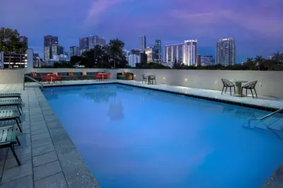a large swimming pool with a city skyline in the background at Tru By Hilton Miami West Brickell in Miami