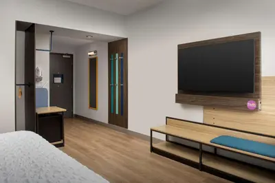 a hotel room with a bed and a flat screen tv at Tru By Hilton Miami West Brickell in Miami