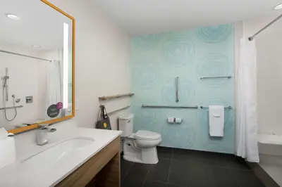 a bathroom with a toilet and a tub and a sink at Tru By Hilton Miami West Brickell in Miami