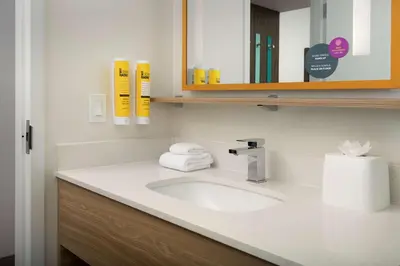 a bathroom with a sink and a mirror at Tru By Hilton Miami West Brickell in Miami