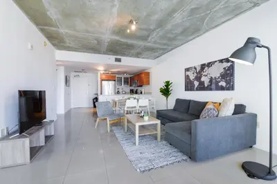 a living room with a couch and a table at Relax Family Midtown - free parking & Great pool in Miami