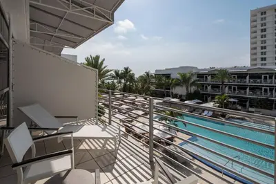 a balcony with a view of a swimming pool at The Ritz-Carlton, South Beach in Miami Beach