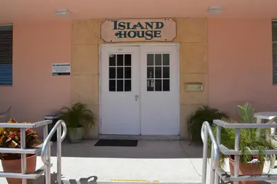 a door to a island house with a sign above it at Island House South Beach in Miami Beach