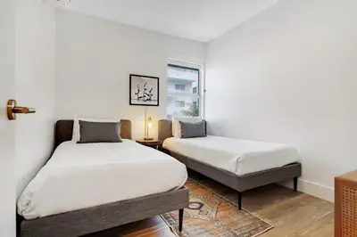 a bedroom with two beds and a window at Roami at The Carmela in Miami Beach