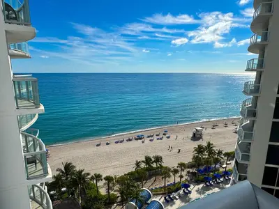 a view of the beach from the balcony of a resort at MVR Apartments at Marenas in Miami Beach