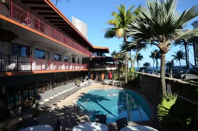 a view of a hotel with a swimming pool and palm trees at Sea Club Ocean Resort in Fort Lauderdale